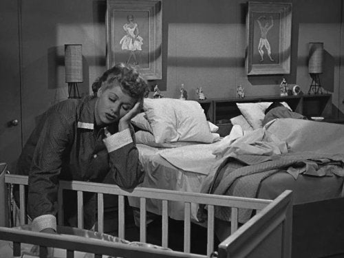 lucille ball standing over crib